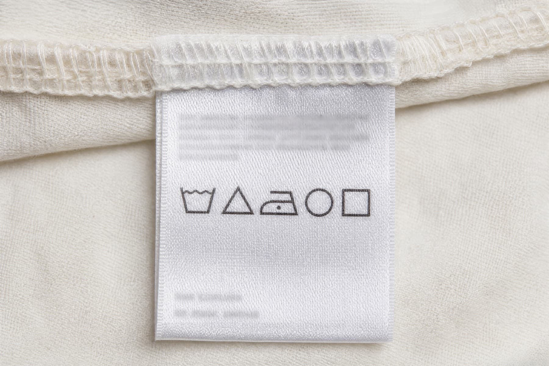 Close-up of the sewn-in care label, showing the laundry symbols